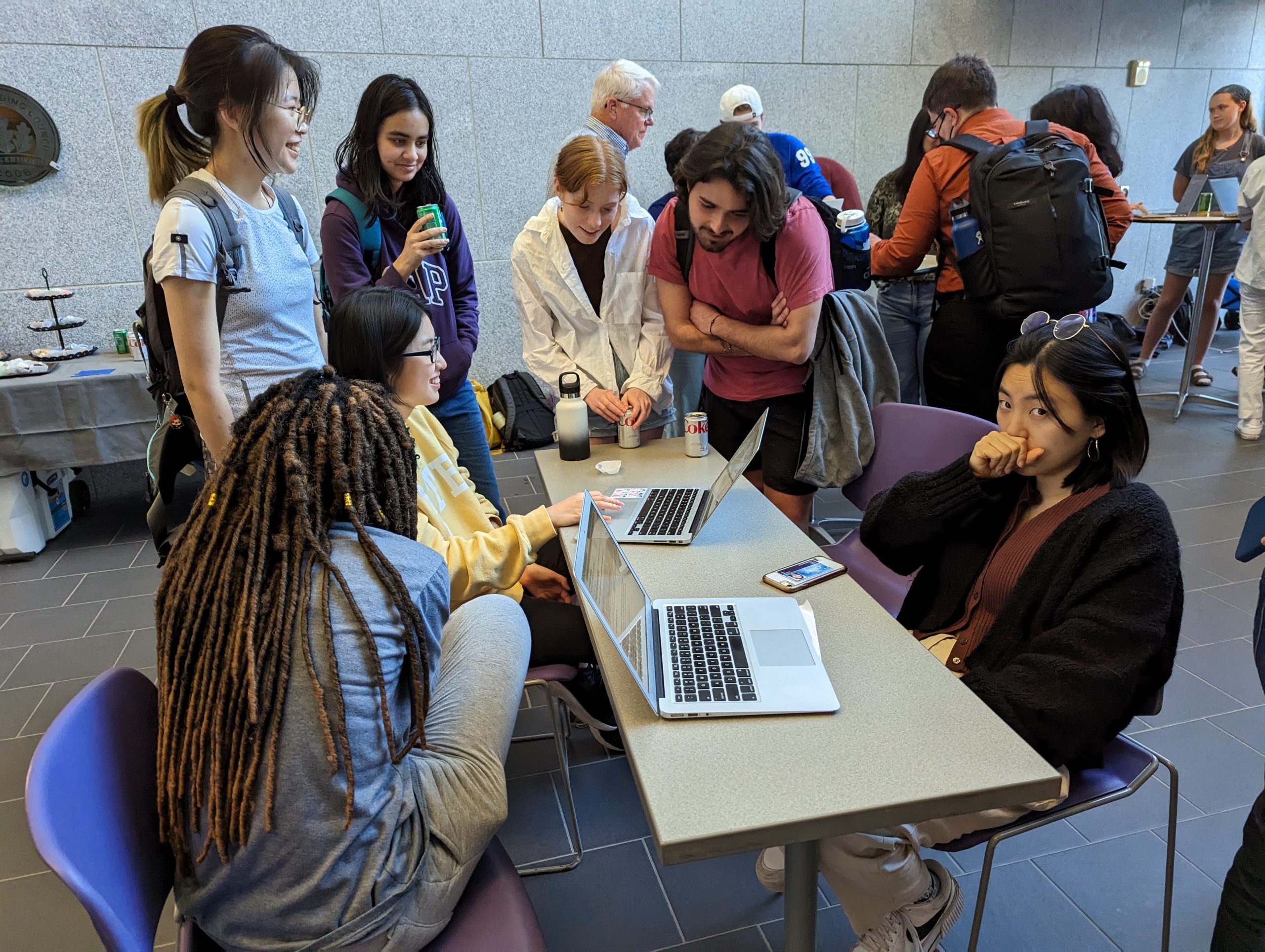 Students around laptops interacting with OpenAI programs